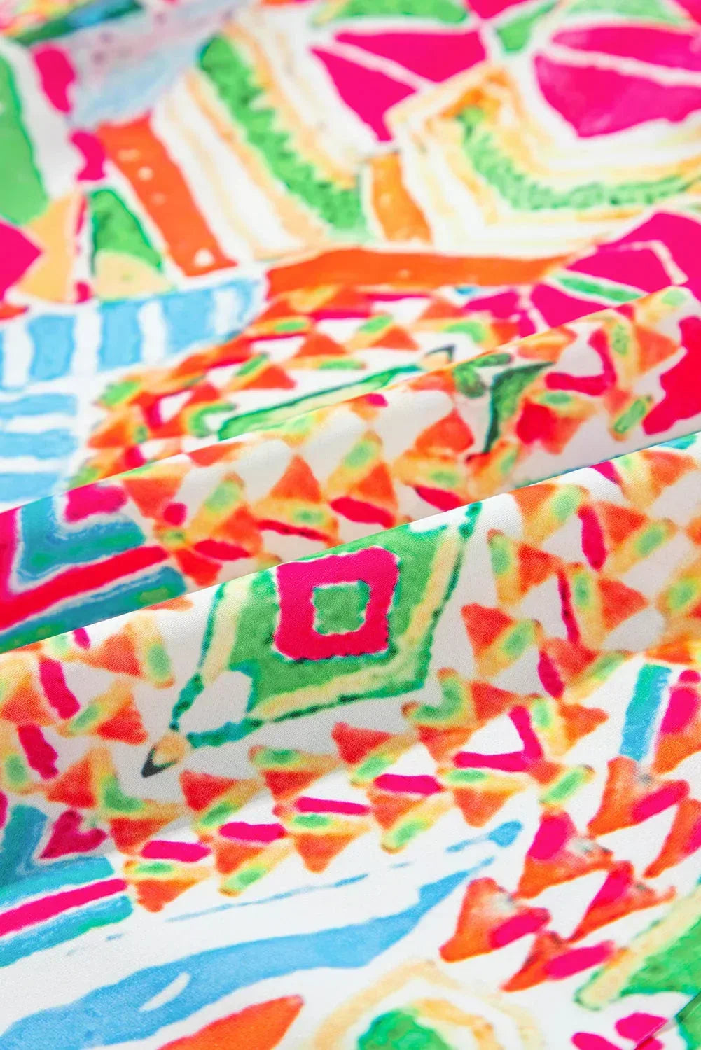 Rainbow - Women's vibrant geometric print mini shirt dress featuring a collared neckline, button-front placket with contrast green trim, and short sleeves.