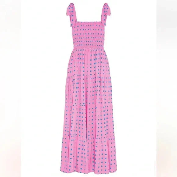Pink - Pink and blue geometric patterned maxi dress featuring a smocked bodice, adjustable tie shoulder straps, and a flowing tiered skirt.