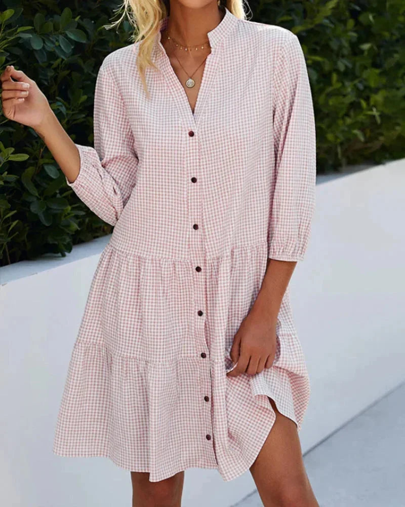 Pink - Light blue and white gingham mini dress featuring a split v-neckline, contrasting button-front closure, three-quarter sleeves, and a voluminous tiered skirt.