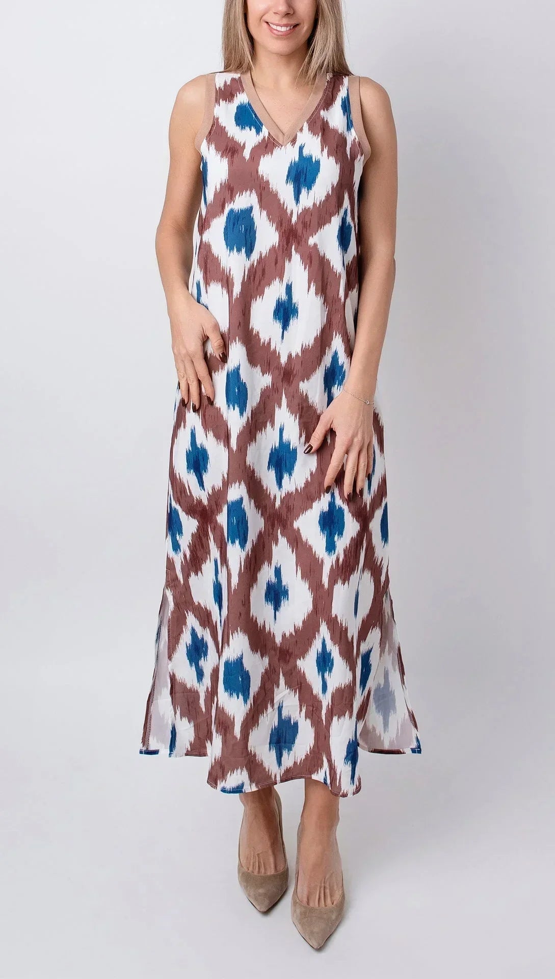 Tropical - Sleeveless midi dress featuring a brown and blue geometric ikat print, contrasting ribbed V-neckline, and side hem slits.