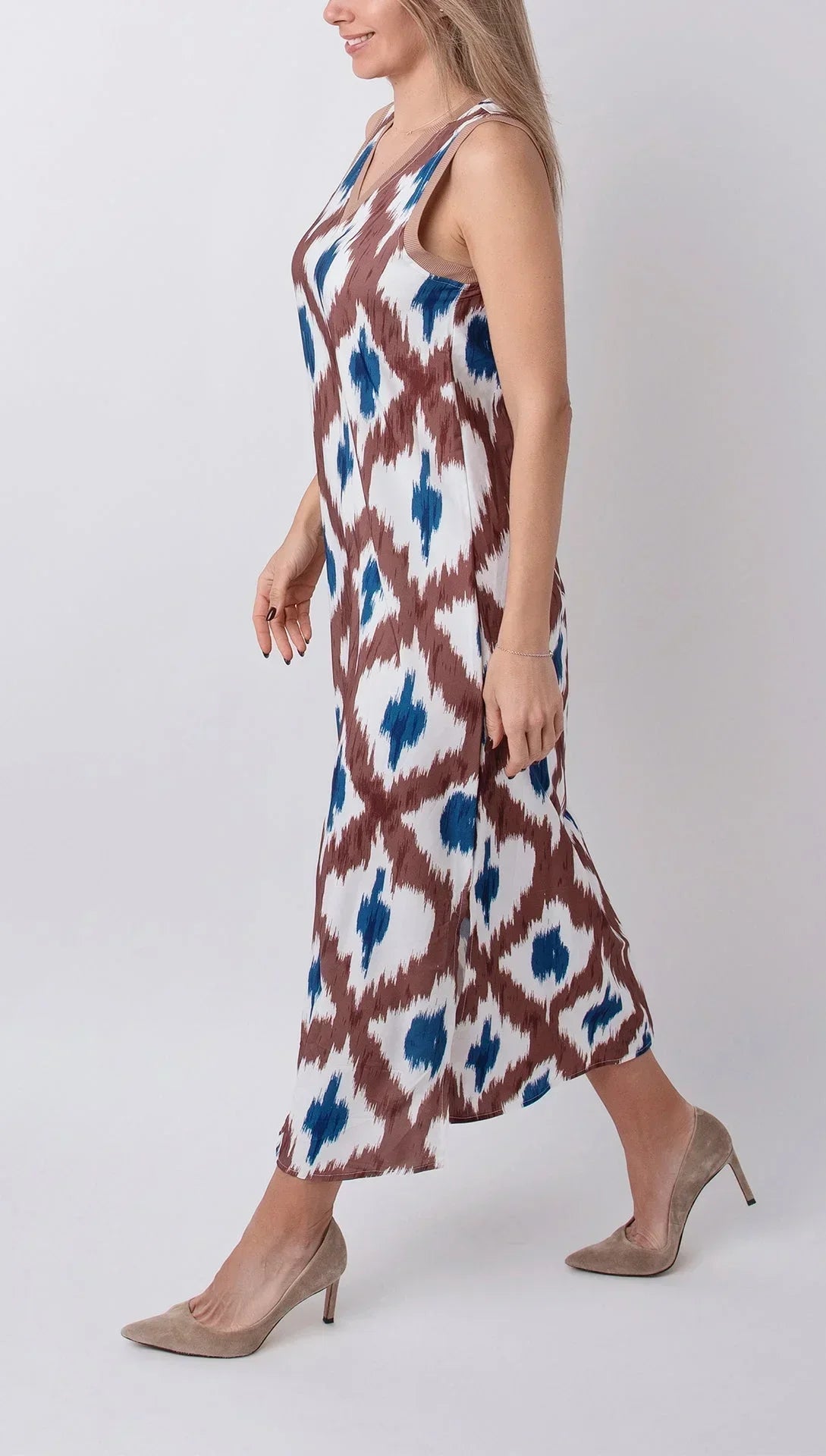 Tropical - Sleeveless midi dress featuring a brown and blue geometric ikat print, contrasting ribbed V-neckline, and side hem slits.