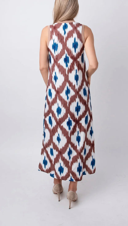 Tropical - Sleeveless midi dress featuring a brown and blue geometric ikat print, contrasting ribbed V-neckline, and side hem slits.