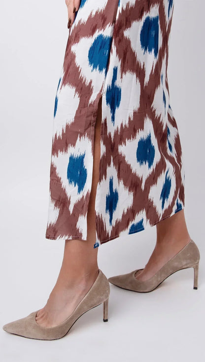 Tropical - Sleeveless midi dress featuring a brown and blue geometric ikat print, contrasting ribbed V-neckline, and side hem slits.