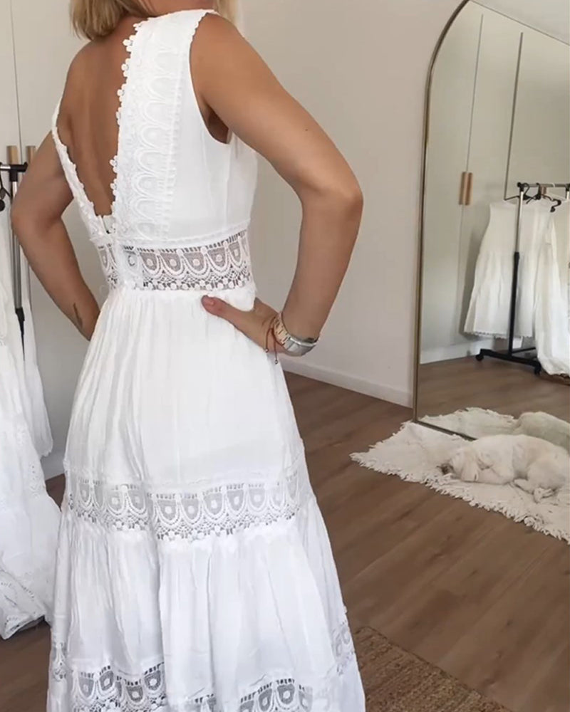 White - A woman wearing a sleeveless white tiered maxi dress with crochet lace inserts at the waist and skirt, featuring a scalloped V-neckline.