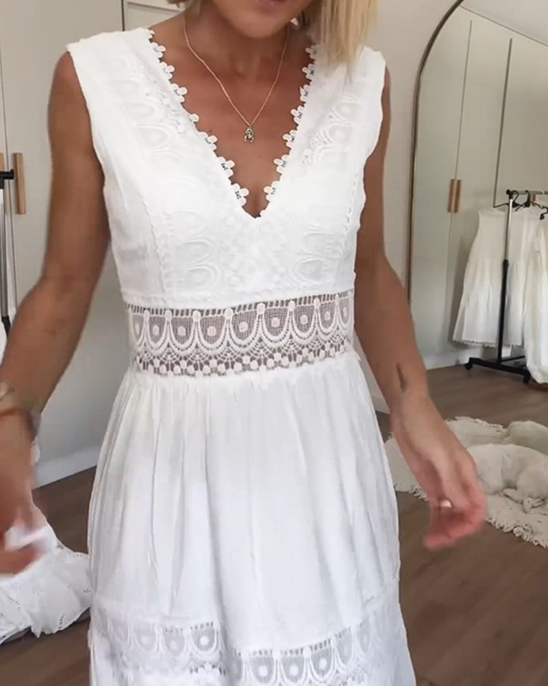 White - A woman wearing a sleeveless white tiered maxi dress with crochet lace inserts at the waist and skirt, featuring a scalloped V-neckline.