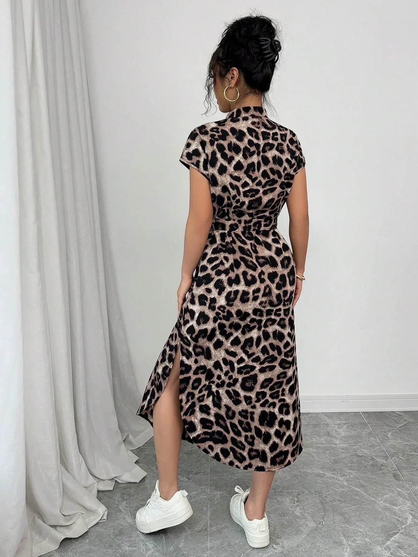 Coffee Brown - Front and back view of a woman wearing a leopard print midi shirt dress with a self-tie belt, button-up front, mandarin collar, and side slits.