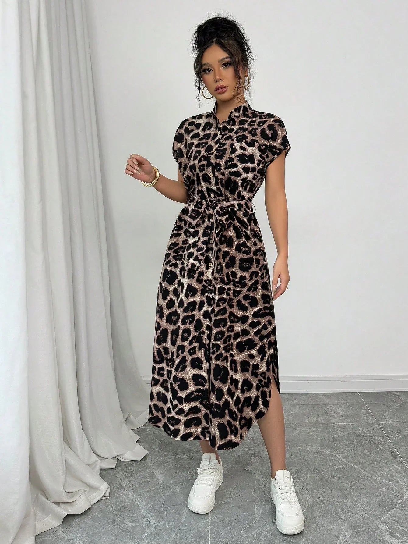 Coffee Brown - Front and back view of a woman wearing a leopard print midi shirt dress with a self-tie belt, button-up front, mandarin collar, and side slits.