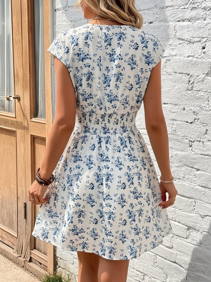 Blue - Woman wearing a lightweight chiffon mini dress with a leopard print, cap sleeves, and a smocked waist