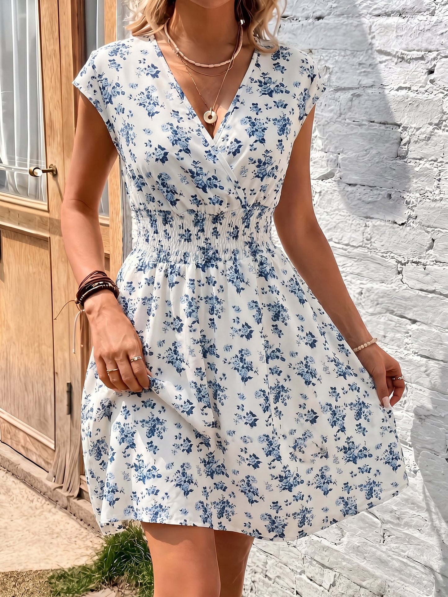 Blue - Woman wearing a lightweight chiffon mini dress with a leopard print, cap sleeves, and a smocked waist