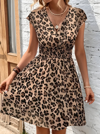 Leopard - Woman wearing a lightweight chiffon mini dress with a leopard print, cap sleeves, and a smocked waist