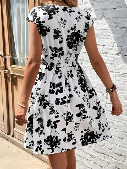White - Woman wearing a lightweight chiffon mini dress with a leopard print, cap sleeves, and a smocked waist