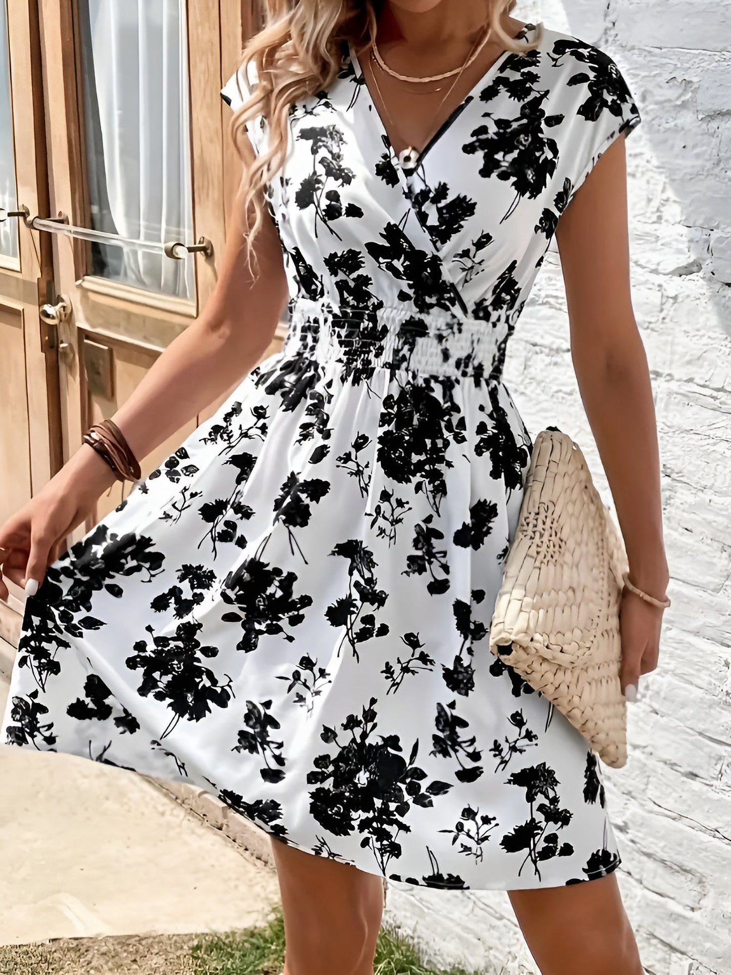 White - Woman wearing a lightweight chiffon mini dress with a leopard print, cap sleeves, and a smocked waist