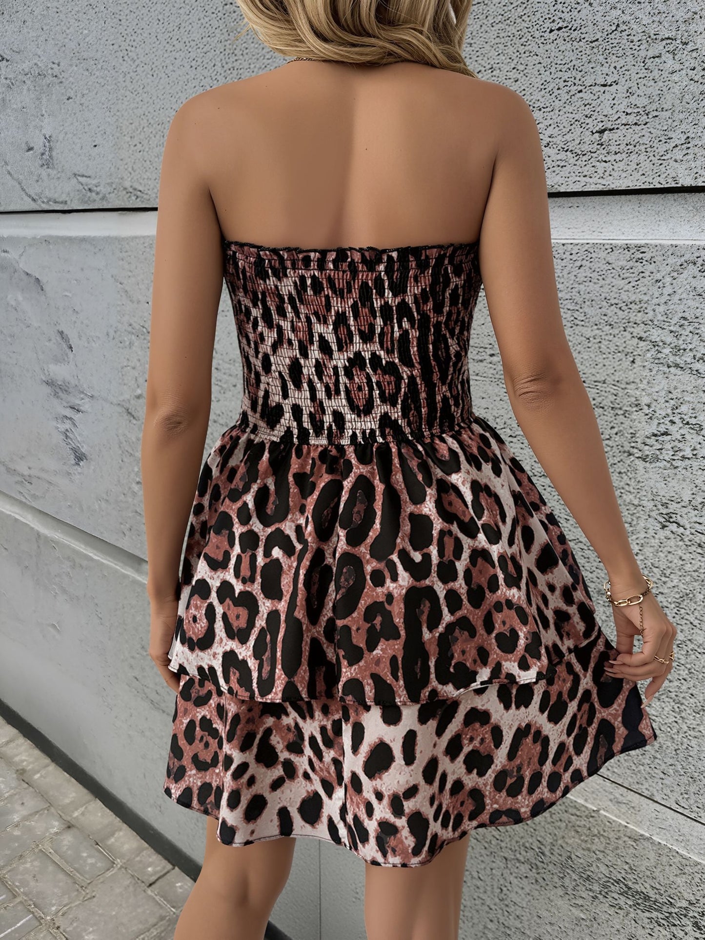 Leopard - Woman wearing a strapless leopard print mini sundress with a smocked bodice and tiered ruffle skirt