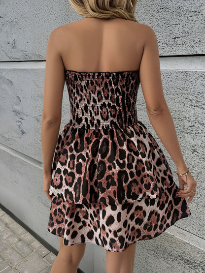 Leopard - Woman wearing a strapless leopard print mini sundress with a smocked bodice and tiered ruffle skirt