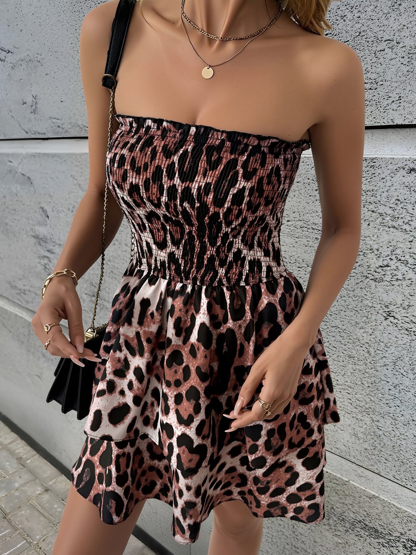 Leopard - Woman wearing a strapless leopard print mini sundress with a smocked bodice and tiered ruffle skirt