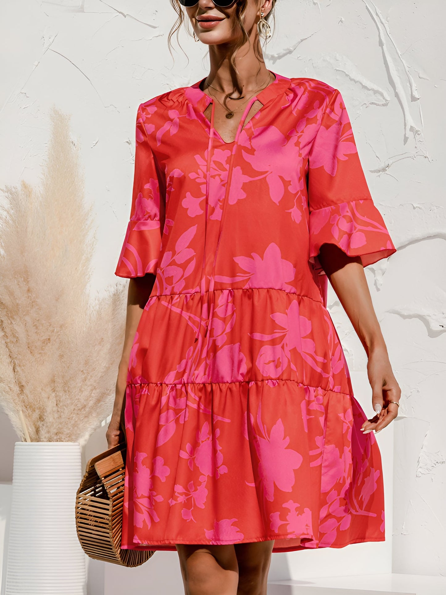 Rose Red - Woman wearing a lightweight leopard print mini dress with flutter sleeves, a tie neckline, and a tiered skirt.