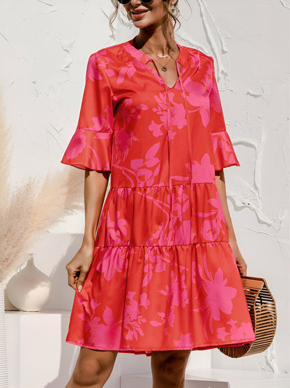 Rose Red - Woman wearing a lightweight leopard print mini dress with flutter sleeves, a tie neckline, and a tiered skirt.