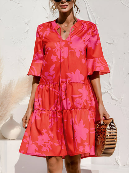 Rose Red - Woman wearing a lightweight leopard print mini dress with flutter sleeves, a tie neckline, and a tiered skirt.