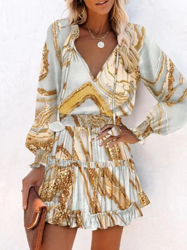 Khaki - Leopard print long-sleeve mini dress featuring a V-neckline with tassel ties, a wide smocked waist, and a tiered ruffle skirt.