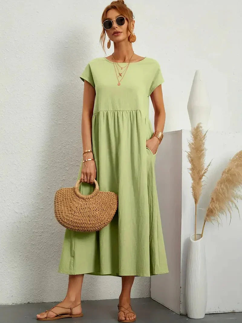 Green - Dark olive green linen-texture midi dress featuring a round neckline, cap sleeves, gathered empire waist, and side seam pockets.