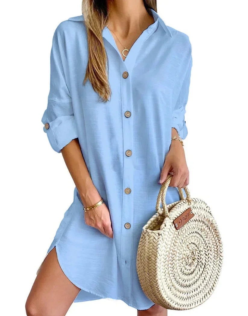 Light blue - White linen button-front mini shirt dress featuring a collared neckline, rolled tab sleeves, and a curved hem with side button details.