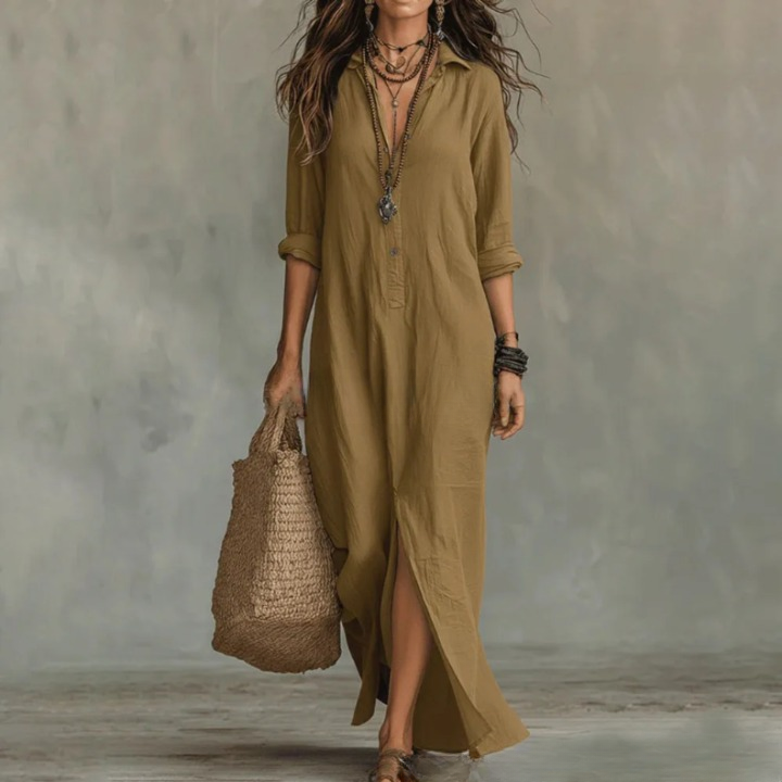 Khaki - A woman wearing a white textured linen maxi shirt dress with rolled sleeves, a partial button placket, and a front split, carrying a woven straw tote bag.