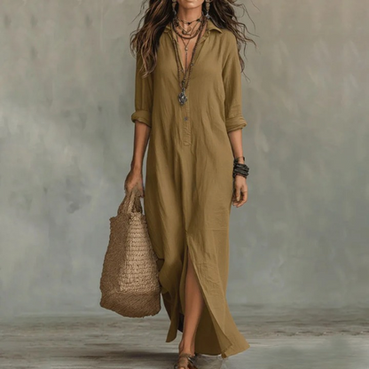 Khaki - A woman wearing a white textured linen maxi shirt dress with rolled sleeves, a partial button placket, and a front split, carrying a woven straw tote bag.