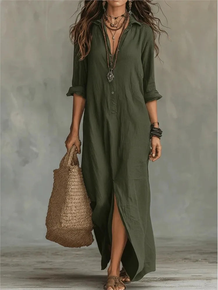 Army Green - A woman wearing a white textured linen maxi shirt dress with rolled sleeves, a partial button placket, and a front split, carrying a woven straw tote bag.