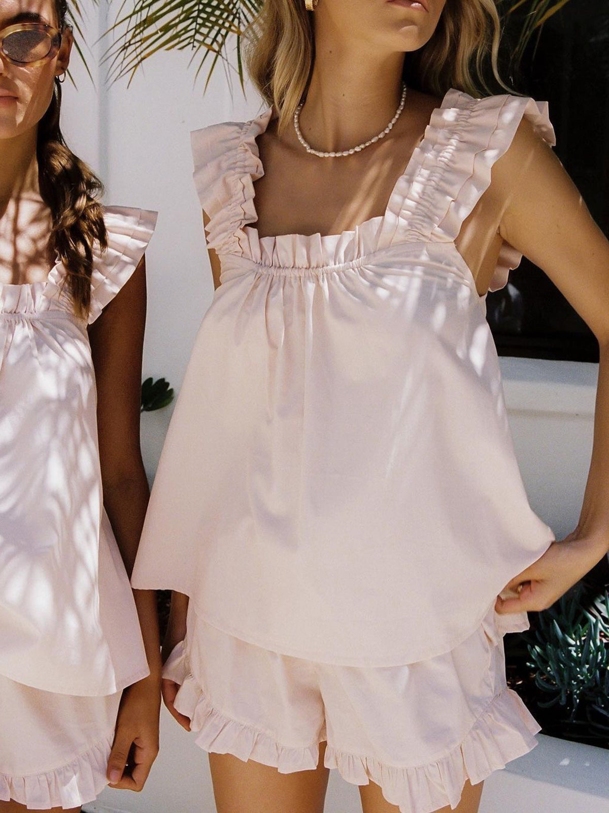 Pink - White linen babydoll top with ruffled flutter straps and a gathered square neckline, worn with matching ruffled shorts.