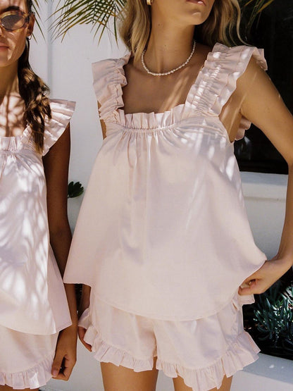 Pink - White linen babydoll top with ruffled flutter straps and a gathered square neckline, worn with matching ruffled shorts.