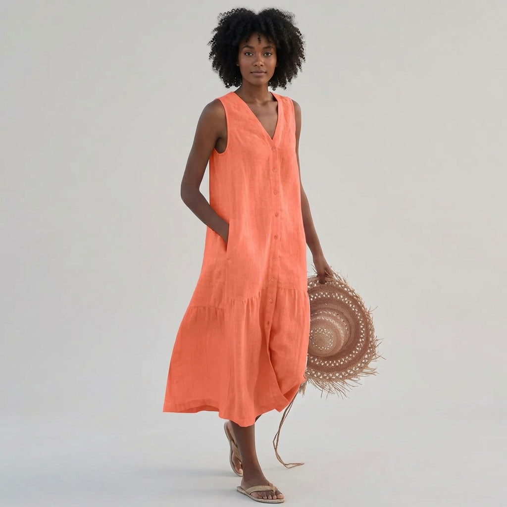 Orange - A woman wearing a sleeveless white linen midi dress with a V-neck, button-down front, and tiered skirt, holding a wide-brimmed straw hat against a neutral background.