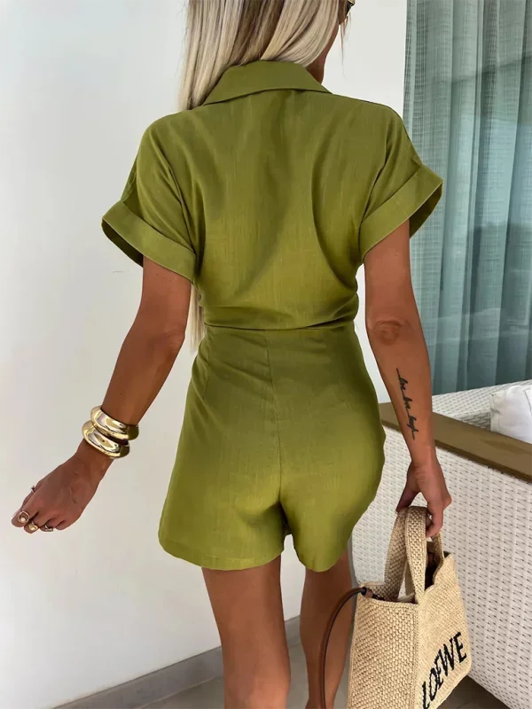 Green - Woman wearing a rust-colored linen-blend mini dress with a collar, deep V-neck, and tie waist, styled with sandals and a straw bag.