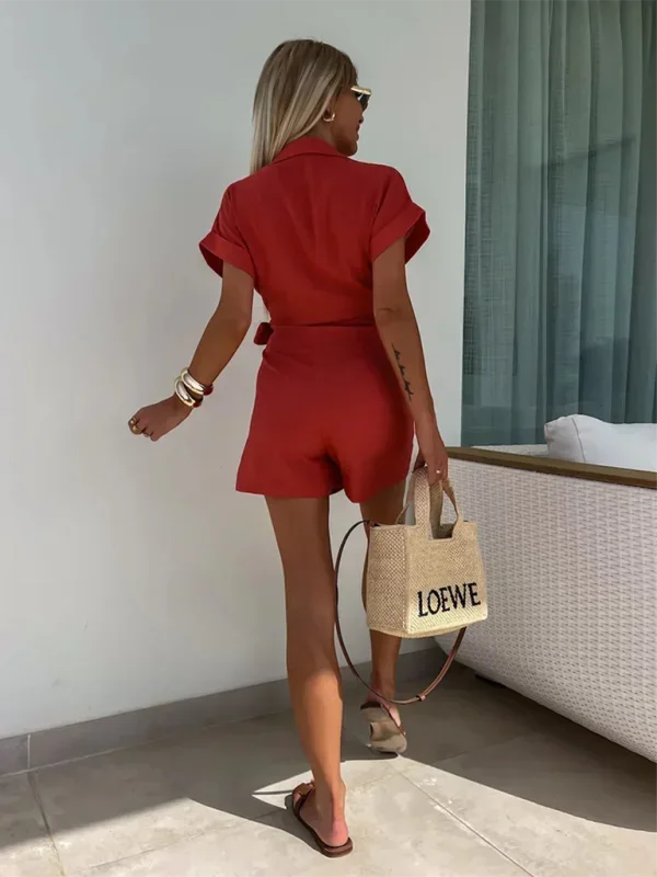 Red - Woman wearing a rust-colored linen-blend mini dress with a collar, deep V-neck, and tie waist, styled with sandals and a straw bag.