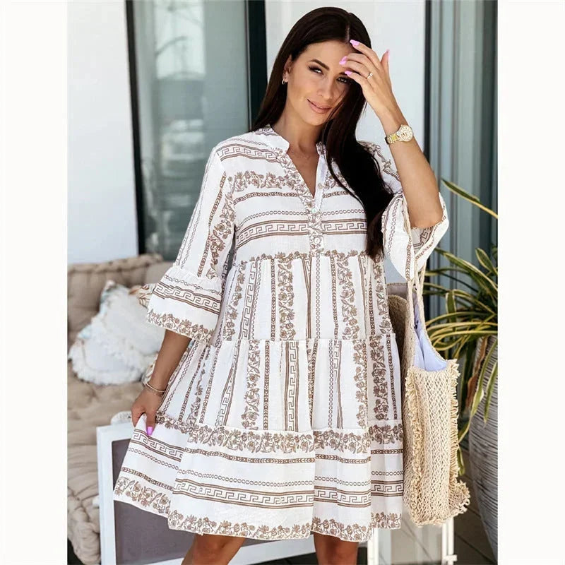 Brown - Light blue and white geometric tile print mini dress featuring a split V-neckline, three-quarter flared sleeves, and a voluminous tiered skirt.