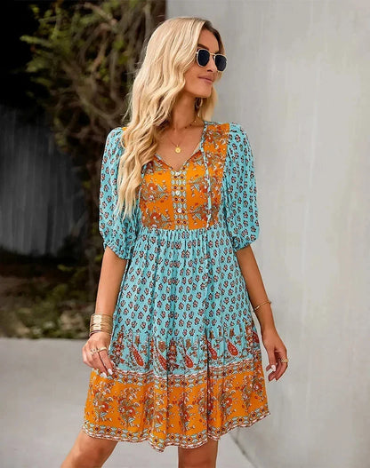 Blue - Light blue and mustard orange mixed floral print dress featuring a split v-neckline with ties, half puff sleeves, and a tiered skirt.