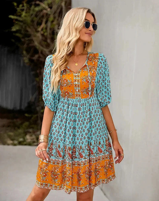 Blue - Light blue and mustard orange mixed floral print dress featuring a split v-neckline with ties, half puff sleeves, and a tiered skirt.