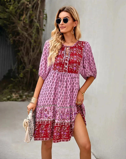 Pink - Light blue and mustard orange mixed floral print dress featuring a split v-neckline with ties, half puff sleeves, and a tiered skirt.