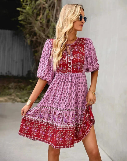 Pink - Light blue and mustard orange mixed floral print dress featuring a split v-neckline with ties, half puff sleeves, and a tiered skirt.