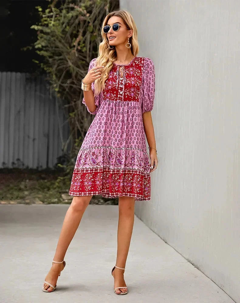 Pink - Light blue and mustard orange mixed floral print dress featuring a split v-neckline with ties, half puff sleeves, and a tiered skirt.