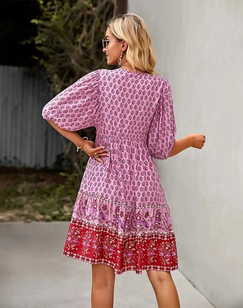 Pink - Light blue and mustard orange mixed floral print dress featuring a split v-neckline with ties, half puff sleeves, and a tiered skirt.