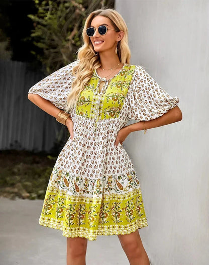 Yellow - Light blue and mustard orange mixed floral print dress featuring a split v-neckline with ties, half puff sleeves, and a tiered skirt.
