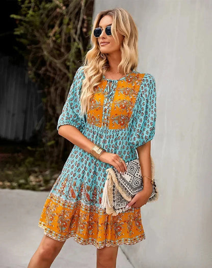 Blue - Light blue and mustard orange mixed floral print dress featuring a split v-neckline with ties, half puff sleeves, and a tiered skirt.