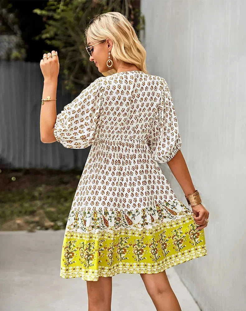 Yellow - Light blue and mustard orange mixed floral print dress featuring a split v-neckline with ties, half puff sleeves, and a tiered skirt.