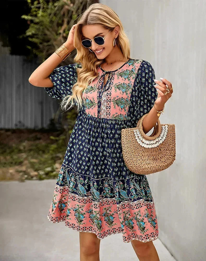 Navy blue - Light blue and mustard orange mixed floral print dress featuring a split v-neckline with ties, half puff sleeves, and a tiered skirt.