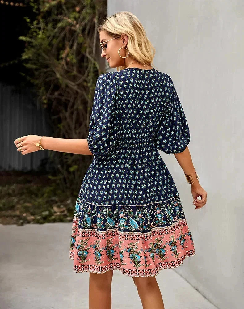 Navy blue - Light blue and mustard orange mixed floral print dress featuring a split v-neckline with ties, half puff sleeves, and a tiered skirt.