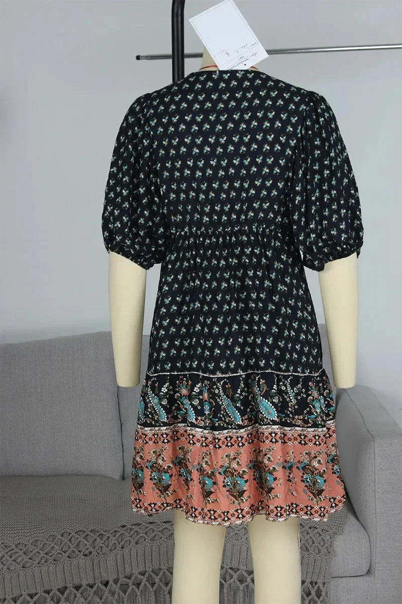 Navy blue - Light blue and mustard orange mixed floral print dress featuring a split v-neckline with ties, half puff sleeves, and a tiered skirt.
