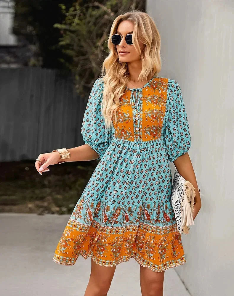 Blue - Light blue and mustard orange mixed floral print dress featuring a split v-neckline with ties, half puff sleeves, and a tiered skirt.