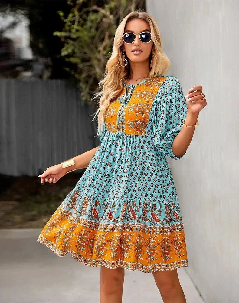 Blue - Light blue and mustard orange mixed floral print dress featuring a split v-neckline with ties, half puff sleeves, and a tiered skirt.