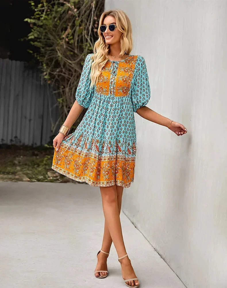 Blue - Light blue and mustard orange mixed floral print dress featuring a split v-neckline with ties, half puff sleeves, and a tiered skirt.