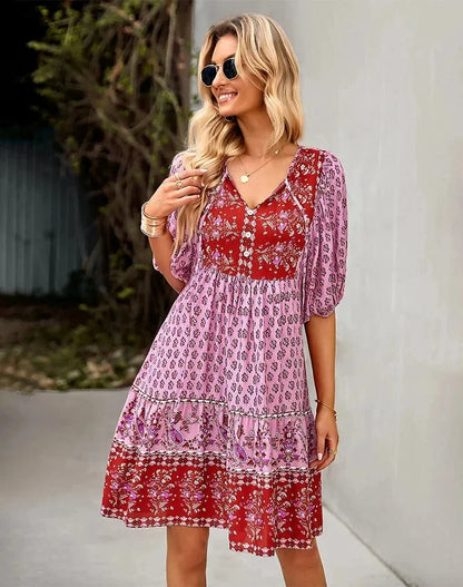 Pink - Light blue and mustard orange mixed floral print dress featuring a split v-neckline with ties, half puff sleeves, and a tiered skirt.
